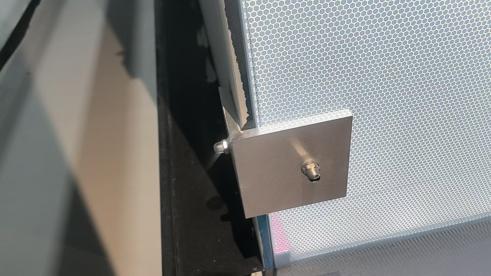 Actual photograph of a glass court mounting connection and printed glass