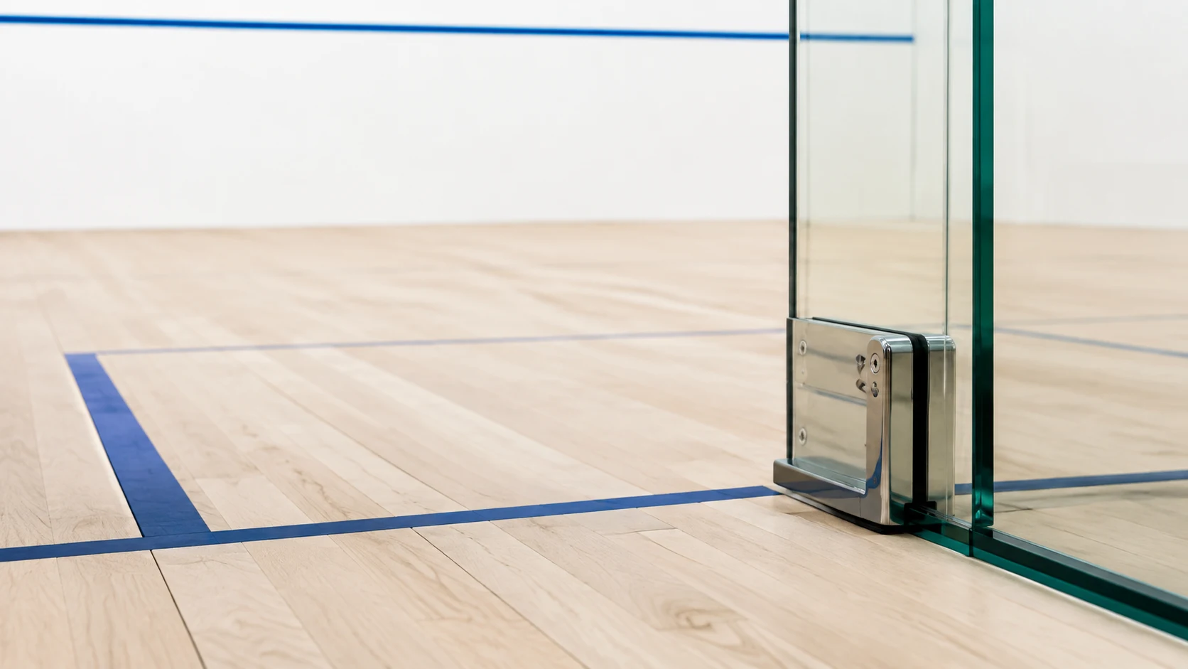 Timber sports floor meeting a squash court wall